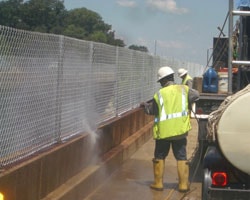 Power Washing the Concrete Wall Preparing for New Bridge Fence